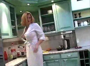 Busty chick in a satin robe in the kitchen