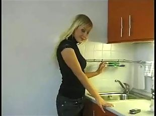 Blonde girlfriend in the kitchen stripping